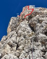 Climber midway up pitch one with upper route visible above.