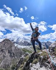 Climber on the summit of Pilastro Moni after Via Rodeo.