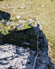 Climber on pitch one of Via Rododendri on Piccola Torre.