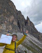 Climber signing the summit book on Piccola Torre after Via Rododendri.