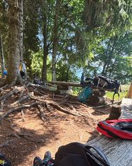 Wooden bench in the pine forest at the base of Piccole Dolomiti with climbing gear