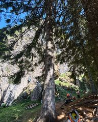 South-facing limestone wall at Piccole Dolomiti with climbers on the routes