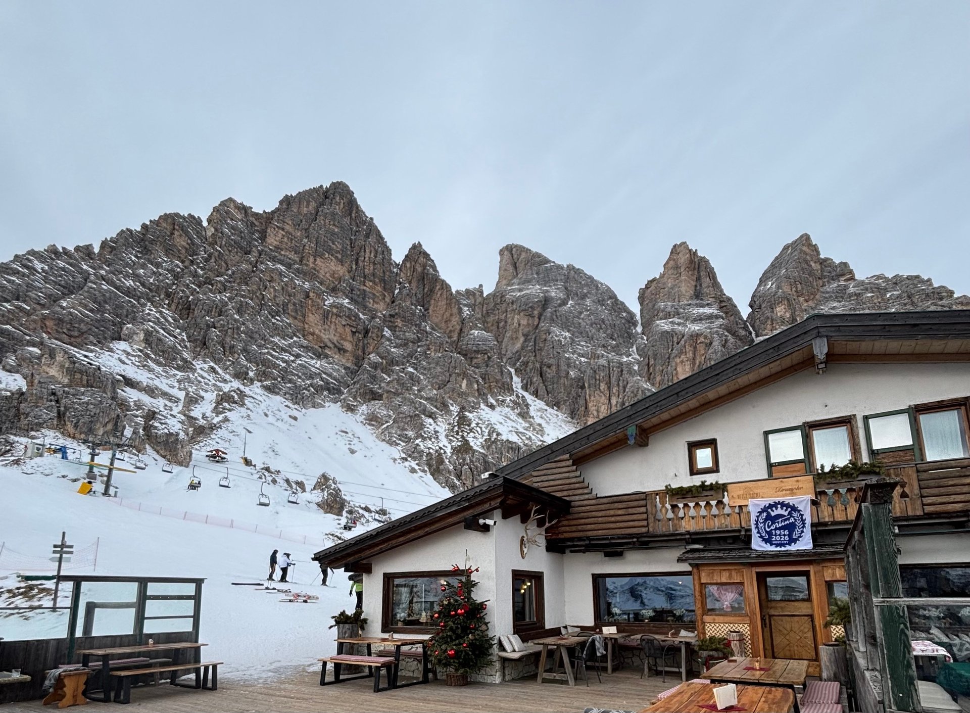 A mountain hut and chairlift below rocky peaks on Tofana.