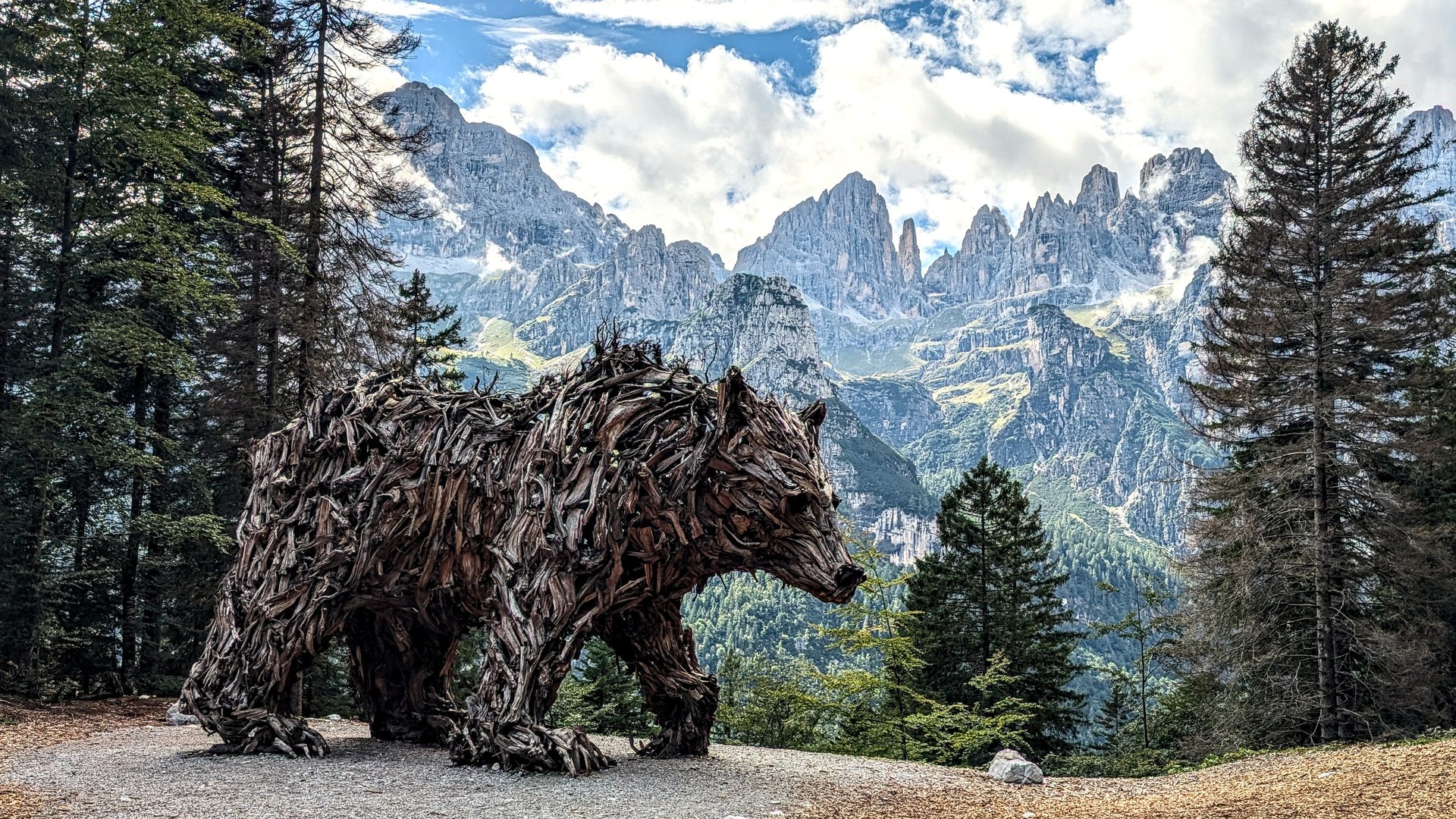 Wooden bear sculpture above Molveno in the Brenta Dolomites