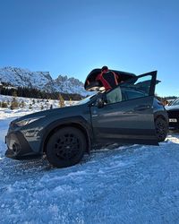 Parking and unloading the snowboards at the Paolina parking lot at Carezza Ski on a sunny winter morning.