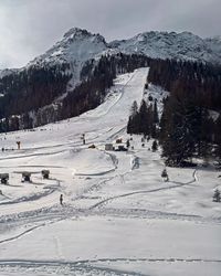 Steep groomed black run dropping from the top of Cima Poppe at Carezza Ski.