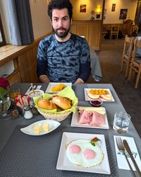 Table full of à la carte breakfast plates, pastries, and coffee at Hotel Lake & River.