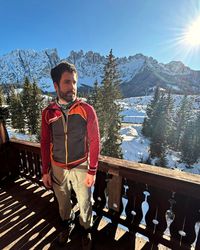 View from the hotel balcony over snow-covered trees and surrounding Dolomite peaks near Carezza.