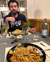 Table at Hotel Lake & River set with Thai dishes and drinks after a ski day at Carezza.