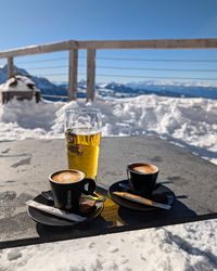 Close-up of coffee and beer on a table at Laurin Lounge during a ski break at Carezza.