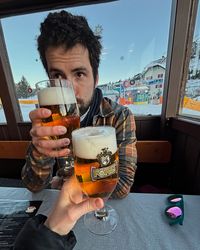 Glasses of beer and aperitivo on a crowded table at the Paolina Snack Bar after skiing at Carezza.