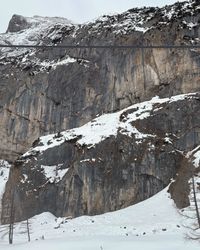 The towering limestone cliffs of the Marmolada massif rising above the valley.