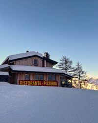 Pizzeria La Cianel sign beside the Bellunese run on Marmolada.