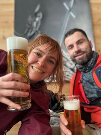 Daysi and David toasting to a successful first snowboarding day of the season in Alpe Cermis.