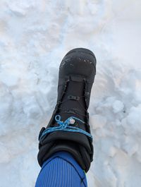 Snowboard boot with a broken BOA temporarily laced with cord as an improvised fix