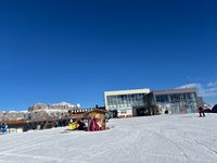 Two sunny benches by the Alba gondola top station in Ciampac