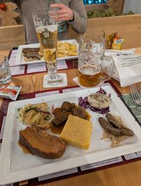 Traditional meat platter at Bierstube Forst in Cortina with sausages, goulash, and sides