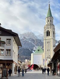 Bell tower in Cortina d'Ampezzo with the Tofana mountain in the background.