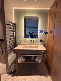 Spacious bathroom at Hotel Serena with heated drying racks for ski gear