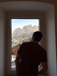 David looking out hotel window checking for fresh snow in Cortina