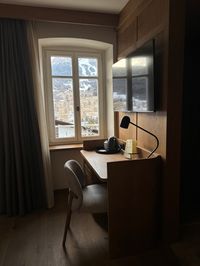 Large window in Hotel Serena room overlooking Dolomites and ski slopes