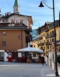 Pedestrian streets of downtown Cortina with shops, cafés, and mountain views
