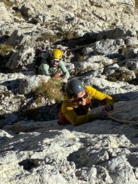 Climber leading the easy opening pitches of Via del Gracchio on Roda di Vael.