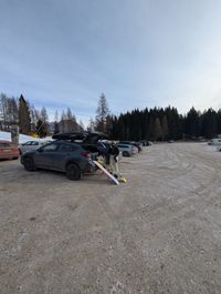 Vehicle parked at free gravel parking lot by Cortina Skyline gondola station, Tofana ski area access point, Cortina d'Ampezzo