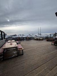 Panoramic outdoor terrace at Rifugio Pomedes with views of Cortina d'Ampezzo town and Cinque Torri rock formations, Tofana, Italian Dolomites