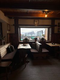 Dolomites mountain panorama visible through windows from inside Rifugio Pomedes at Olympic slope summit, Tofana, Cortina d'Ampezzo