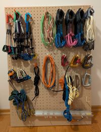 Climbing gear organized on a pegboard with 3D-printed pegs