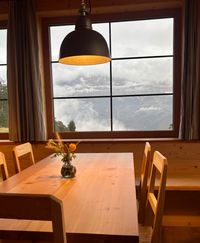 Wood-paneled dining room setup inside Tschafon Hut