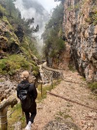 Rain-soaked trail along an alpine stream returning to Tschafon Hut
