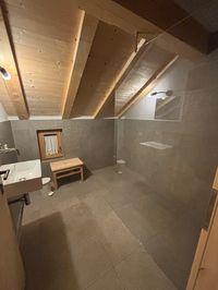 Shared indoor shower at Tschafon Hut.