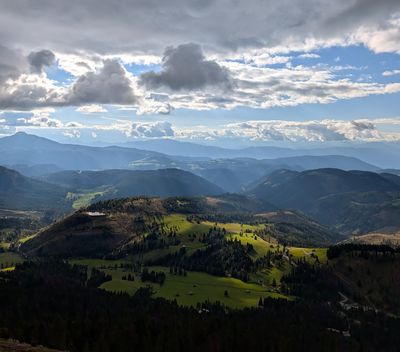 Sunlit green ridges and valleys across Trentino