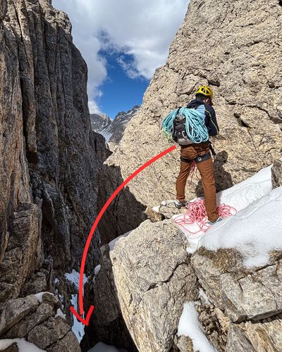 Climber setting up the rappel at the top of the shortcut.