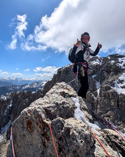 Climber standing on the summit of Torre Finestra.