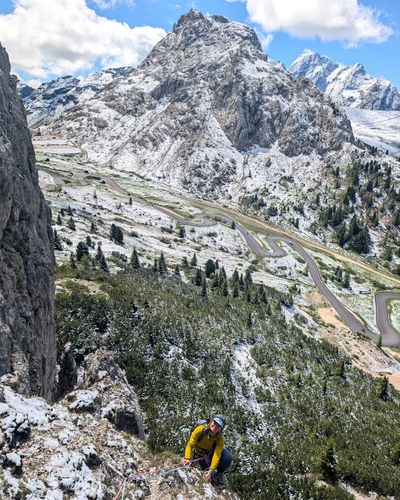 Climber on the grassy start of pitch one on Via Rodeo.