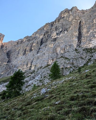 Steep grassy meadow below the west face of Piccola Torre.