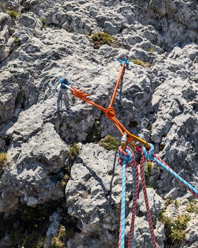 Bolt and piton anchor at the top of pitch one on Via Rododendri.