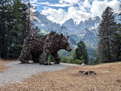 Wooden bear sculpture above Molveno in the Brenta Dolomites