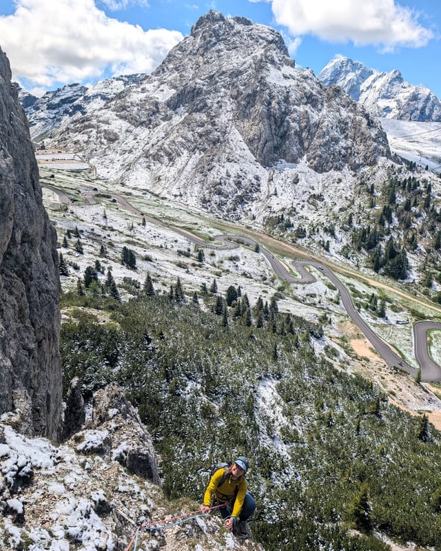 Climber on the grassy start of pitch one on Via Rodeo.