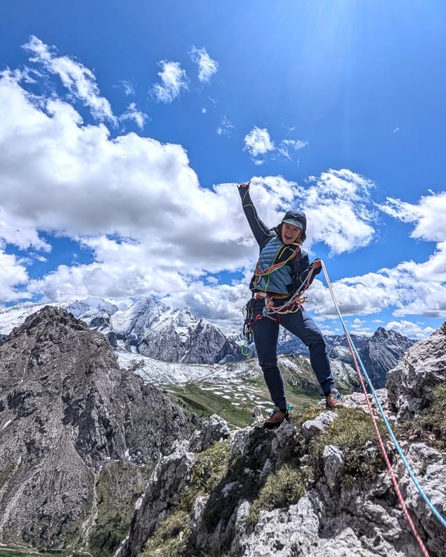 Climber on the summit of Pilastro Moni after Via Rodeo.