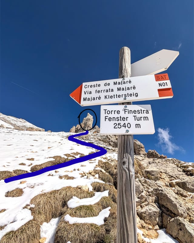 Second fork and meadow trail leading from the ferrata exit to the climb base.