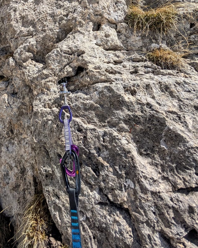 Traditional gear placements in cracks on the first pitch.
