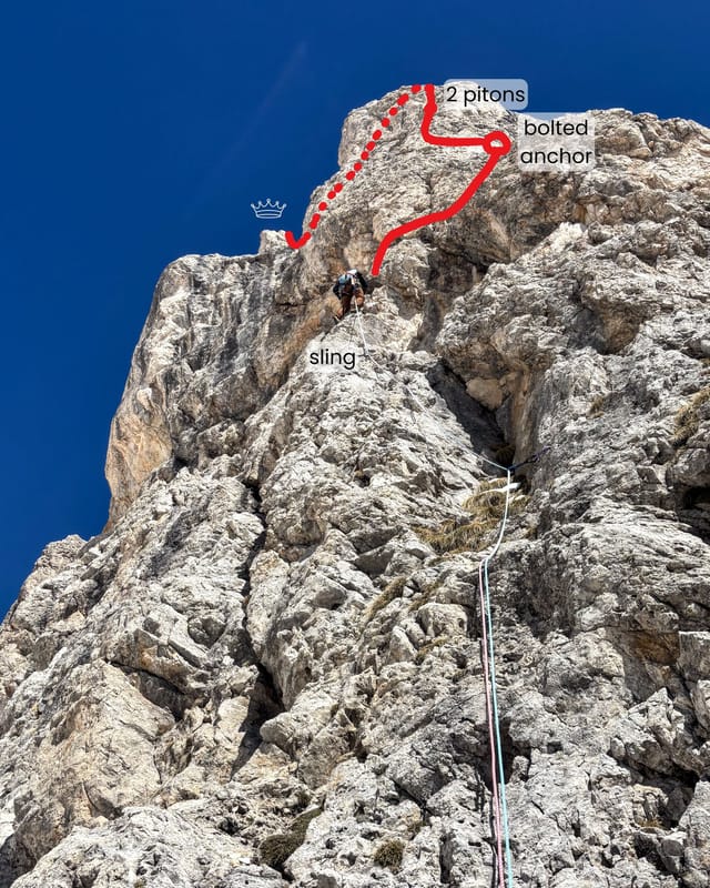Climber midway up pitch one with upper route visible above.