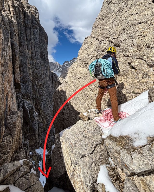 Climber setting up the rappel at the top of the shortcut.