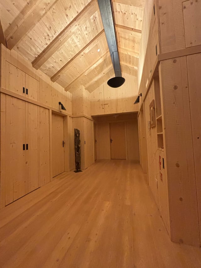 Upstairs common room with charging station at Tschafon Hut